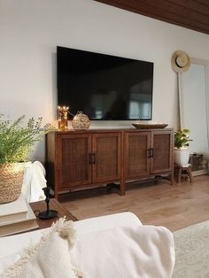 a flat screen tv sitting on top of a wooden cabinet