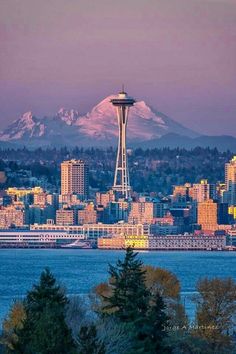 the space needle in seattle, with mt rainier in the background