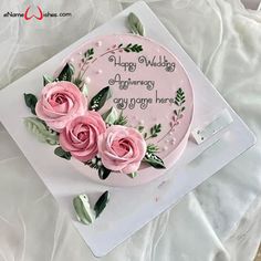 a birthday card with pink roses and greenery on the front, sitting on top of a white sheet