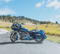 a blue motorcycle parked on the side of a road