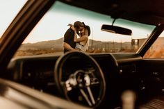 a man and woman kissing in the back seat of a car