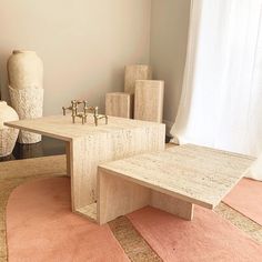 a living room filled with furniture and vases on top of carpeted flooring