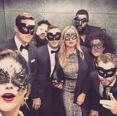 a group of people wearing masks posing for a photo