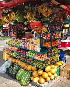 a fruit stand with lots of fruits and vegetables