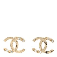 This is an authentic pair of CHANEL Crystal CC Earrings in Gold. These classic earrings feature a gold CC stud with Chanel engraved on each C. Designer Gold-tone Earrings As Gift, Designer Gold-tone Earrings For Formal Occasions, Designer Tarnish Resistant Gold Earrings, Designer Gold Tarnish Resistant Earrings, Designer Gold Round Earrings, Classic Yellow Gold Earrings With Logo Plaque, Designer Gold Earrings For Anniversary, Luxury Gold-tone Earrings With Logo Plaque, Designer Gold-tone Logo Plaque Earrings For Formal Occasions