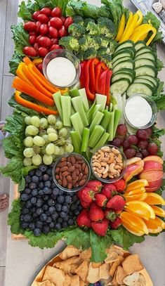 a platter filled with fruits and vegetables on top of a table