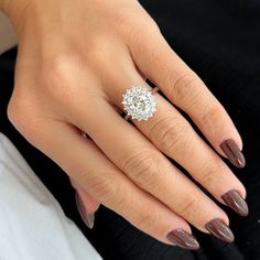 a woman's hand with a diamond ring on it