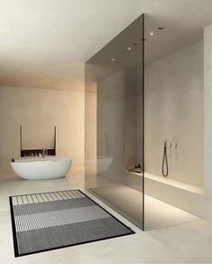 a bathroom with a large glass shower door and white bathtub next to a sink