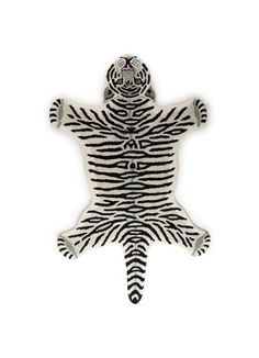 a white and black zebra print rug with a hoodie on it's head