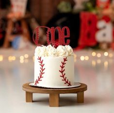 a baseball themed birthday cake with the number one on it's top and red stitches