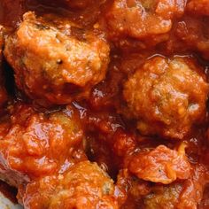 meatballs covered in marinara sauce on a plate