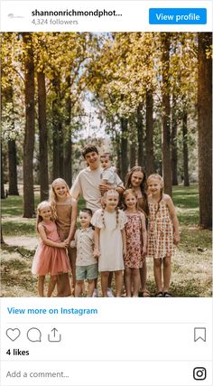 the family is posing for a photo in front of some trees with their names on it