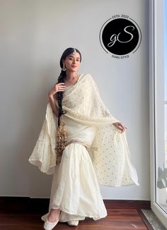 Festive Off-white Georgette Sharara, Off White Designer Sets For Diwali, Off White Georgette Sets With Traditional Drape, Georgette Sharara With Sheer Dupatta For Diwali, Fitted White Lehenga With Dabka Detail, Fitted White Lehenga With Dabka, Off White Semi-stitched Georgette Sharara, Off White Chanderi Sets For Diwali, Off White Georgette Sharara For Festive Occasions