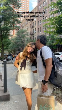 a man and woman standing next to each other in front of a building with the words happy birthday dad i love you with all my heart