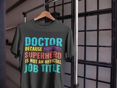 a doctor t - shirt is hanging on a rack in front of a metal door