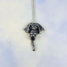 The Serene Bat Cat necklace features a fully 3D, darkened sterling silver black cat with bat wings and bat-like ears, with wings folded forward in a restful position. The edges of the wings, face and paws are polished to highlight the adorable details. The backside is stamped with both 925 and my XF maker's mark. Comes strung on a sterling silver curb chain of your chosen length. The Bat Cat measures approx. 33mm tall by 25mm wide (at the wings) Due to the handcrafted nature of my items, please allow approximately 2 weeks for production. Thank you! Black Cat With Bat Wings, Cat With Bat Wings, Wings Folded, Bat Cat, Vial Necklace, Lion Necklace, Major Tom, The Wings, Cat Necklace