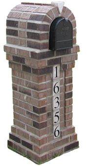 a brick mailbox with the number 1560 on it's front and side