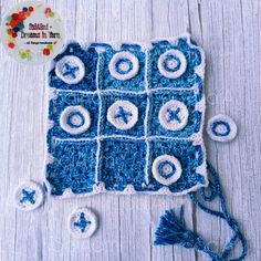 a crocheted blue and white square with buttons