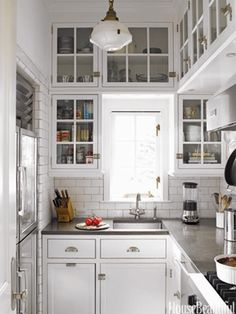 a kitchen with white cabinets and stainless steel appliances in the center, is featured on instagram