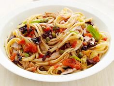 a white bowl filled with pasta and vegetables