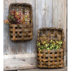 two wooden baskets with plants in them