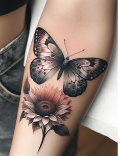 a woman's arm with a butterfly and sunflower tattoo on the left side