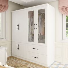 a large white closet with lots of clothes hanging on it's doors and drawers