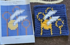 a crocheted square with a bee on it next to a pattern for a rug