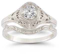 a white gold engagement ring set with an old - fashioned style diamond in the center