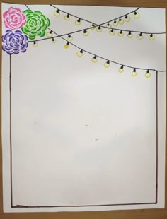 a piece of paper that has been drawn with markers and string lights attached to it