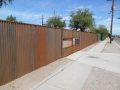 a long metal fence on the side of a road