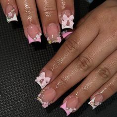 a woman's nails with pink and white designs on them, one has a bow at the top