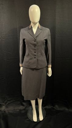 Classic 1940s skirt suit in fab condition. The fabric is finely ribbed and has a lovely contrast collar and cuff detail in a grosgrain which elevates the general look of the suit which the pretty buttons do as well. The skirt fastens with a zipper and it has been dry cleaned. Jacket- Bust 36" Waist 28" Sleeve length 22" Skirt- Waist 28" Hips 38" Waist to hem 28.5" Suits Photography, 1940s Skirt, 1940s Suit, 1940s Women, Pretty Buttons, Womens Suits, Twelfth Night, Work Suits, Beautiful Suit