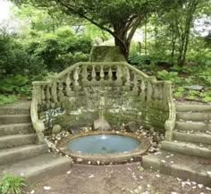 an old stone staircase with a fountain in the middle