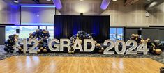 an indoor basketball court with large letters spelling out the word grad in front of it