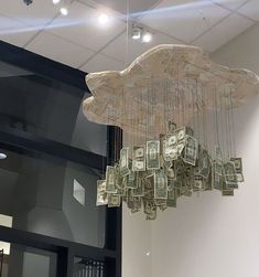 a bunch of money is hanging from the ceiling