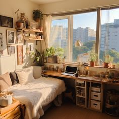 a bedroom with a bed, desk and laptop on the window sill in front of large windows