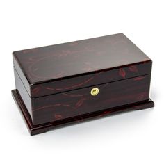 a small wooden box with a handle on the top and gold inlays to it