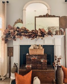 a living room filled with furniture and a mirror on top of a fireplace mantel