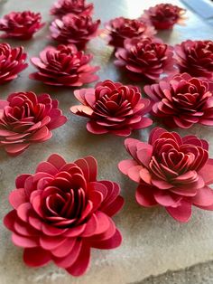 red paper flowers sitting on top of a table