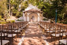 an outdoor wedding venue with rows of chairs