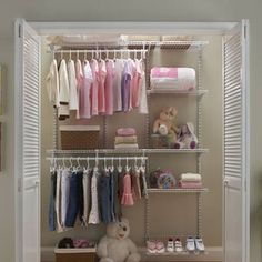 the closet is organized with baby clothes and toys