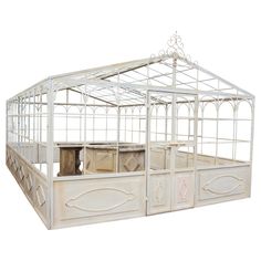 a white metal and wood bed frame with glass doors on the top part, in front of a white background