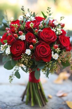 a bouquet of red roses and white flowers