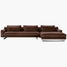 a brown leather sectional sofa with pillows on the top and bottom, sitting in front of a white background