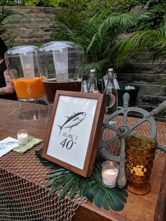 there is a sign on the table with drinks