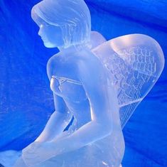 a white statue sitting on top of a blue sheet