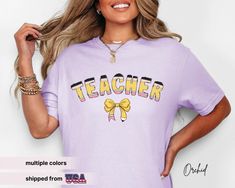 Celebrate your favourite educator with our coquette teacher bow shirt, a stylish Comfort Colors teacher shirt designed as the perfect appreciation gift for everyday use of your teacher's life. Whether it's for a kindergarten teacher or a math teacher, this teacher team shirt with coquette pencil box makes a delightful and thoughtful Christmas gift for her! 𝔻𝔼𝕋𝔸𝕀𝕃𝕊 👚 Material: high quality 100% ring-spun US cotton for long-lasting comfort  👚 Made using 100% US cotton that is ethically gr Kindergarten Teacher Shirts, Teacher Team, Thoughtful Christmas Gifts, Bow Shirts, Team Shirts, Kindergarten Teachers, Christmas Gifts For Her, Teacher Life, Teacher Shirts