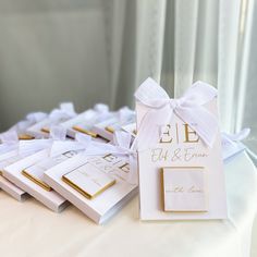 the table is set up with white and gold place cards