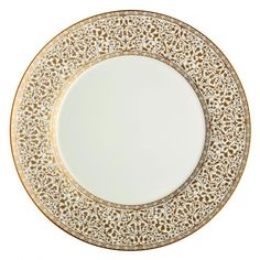 a white and gold plate with an intricate design on the rim, against a white background